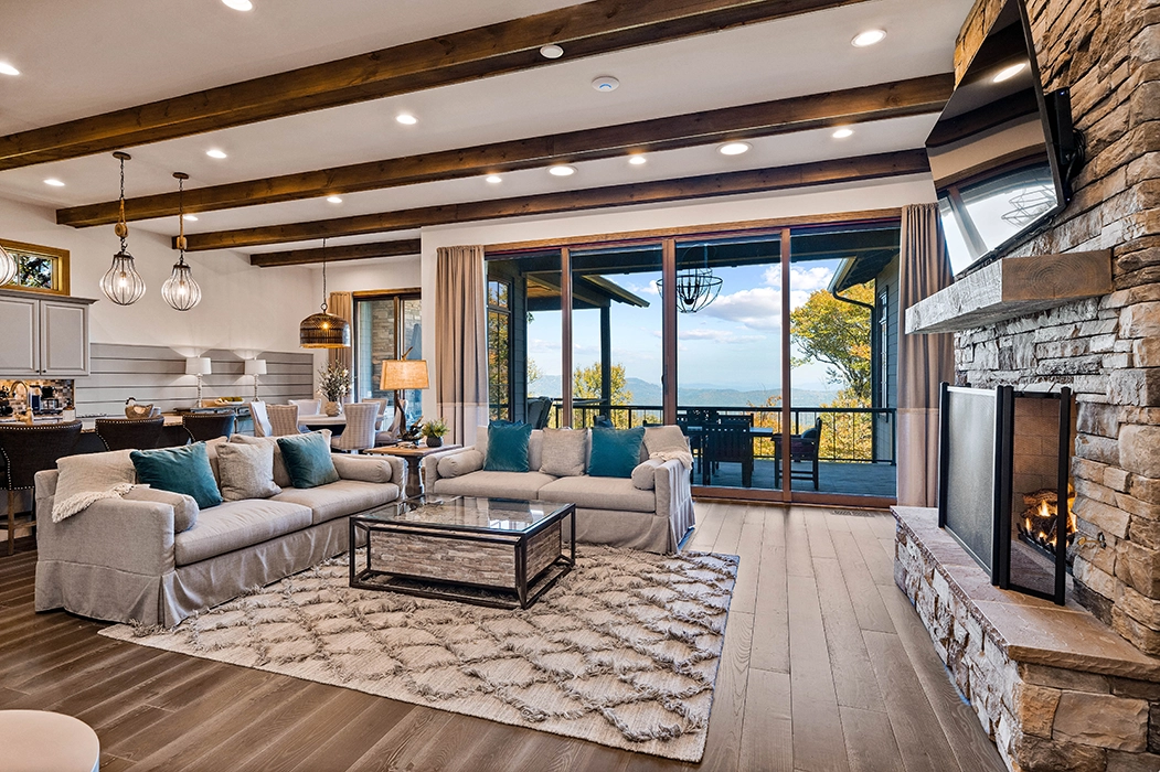 living room interior with large sliding windows to the deck that overlooks the mountains