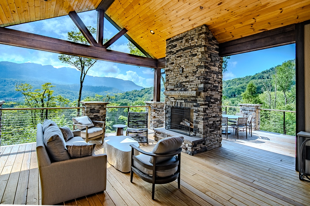 cover deck with fireplace overlooking the mountains