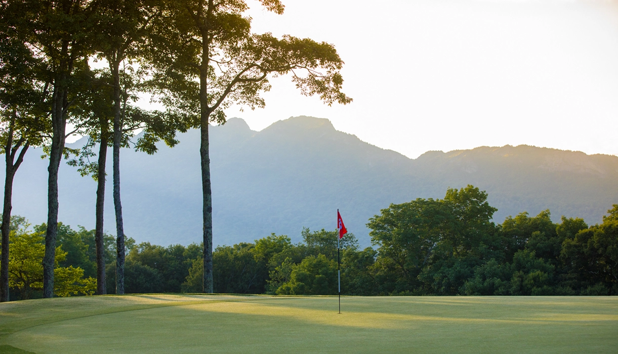 golf course putting green with mountains in background